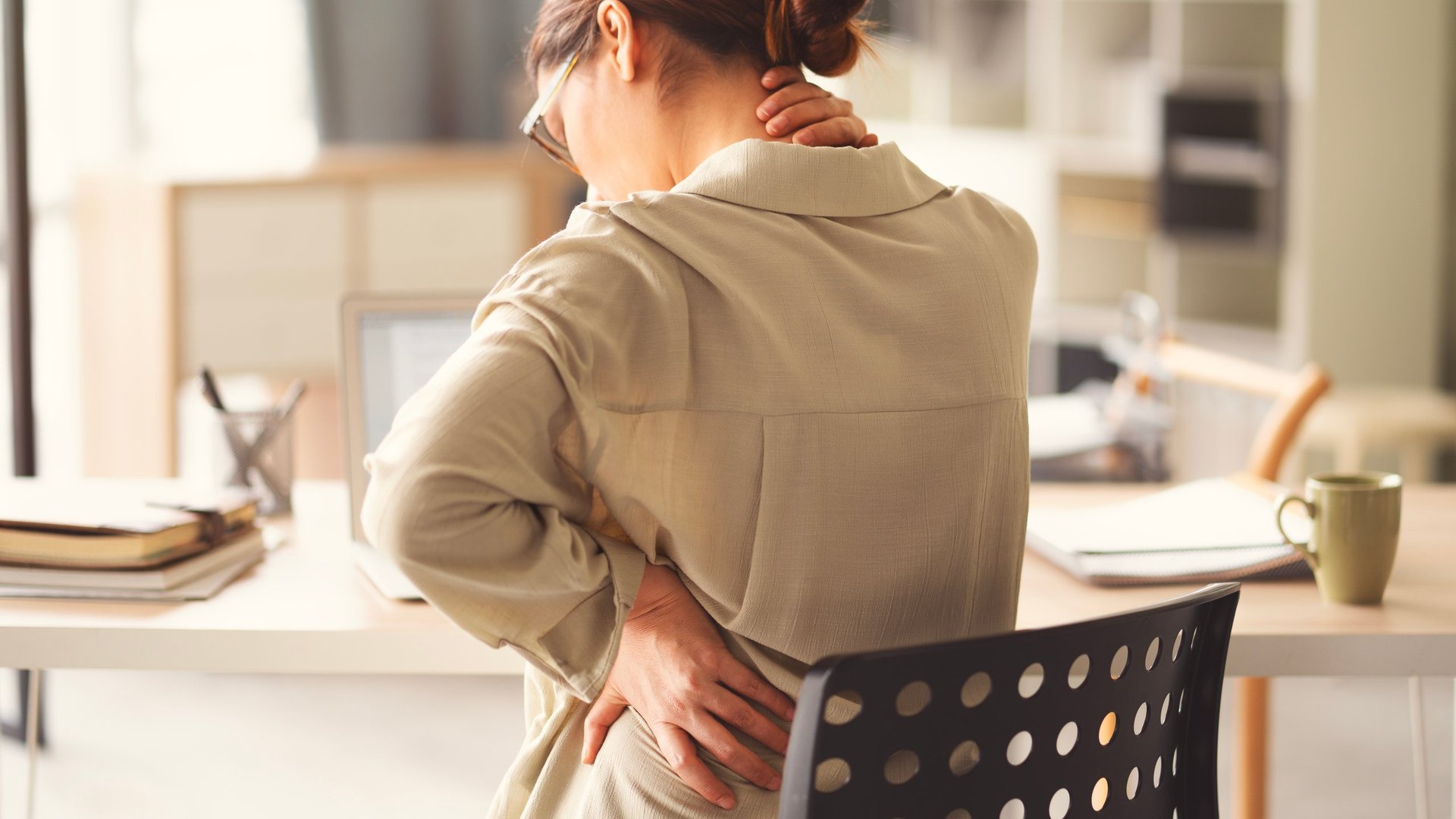 Business woman with back and neck pain